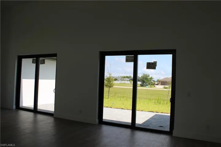 Doorway to outside with wood finished floors and a residential view
