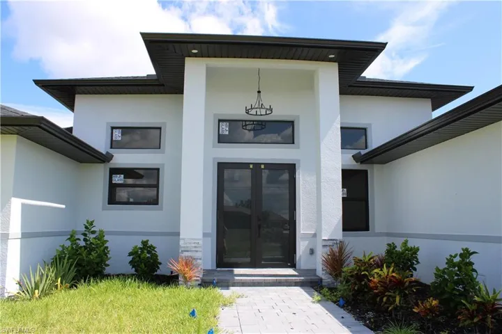 Entrance to property with stucco siding and french doors