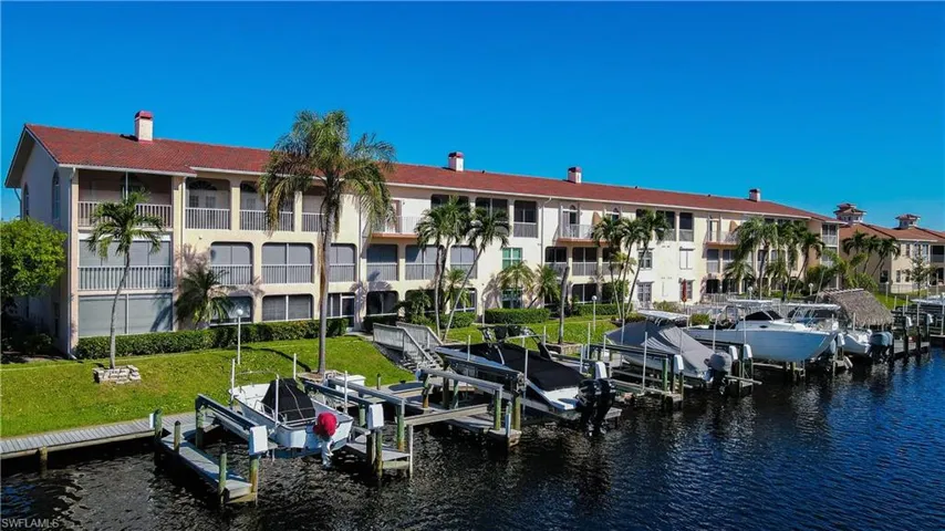 Dock area with a water view and a yard