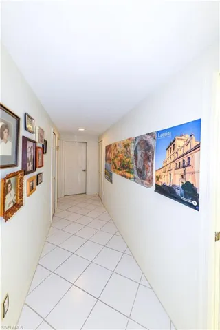 Corridor with light tile patterned flooring