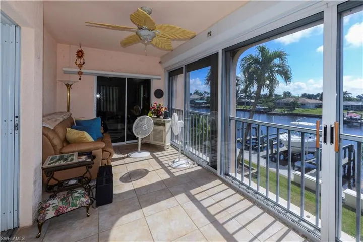 Sunroom with a water view and ceiling fan