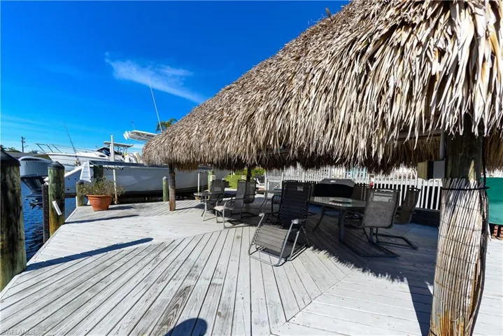 Wooden terrace featuring a gazebo and a water view
