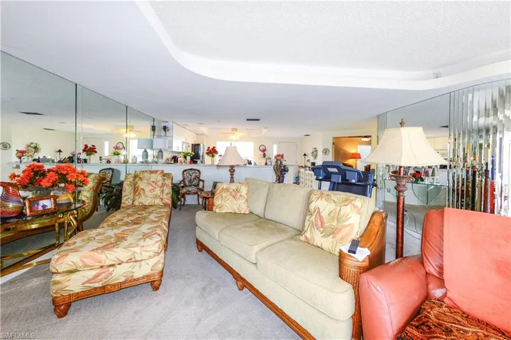 Carpeted living room featuring a textured ceiling