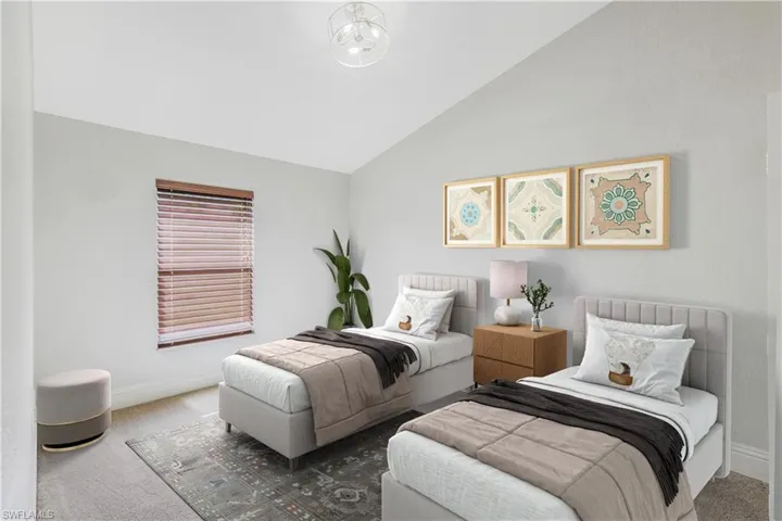 Carpeted bedroom with high vaulted ceiling