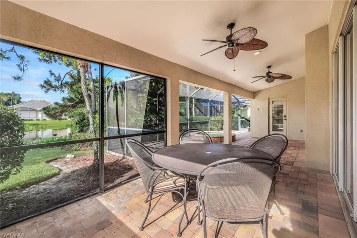 Sunroom featuring a water view and ceiling fan