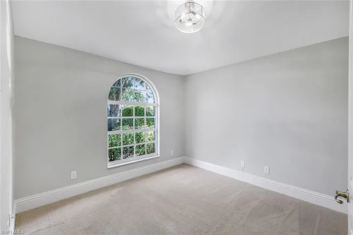 Unfurnished room with plenty of natural light and light colored carpet
