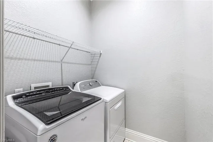 Washroom featuring washing machine and dryer