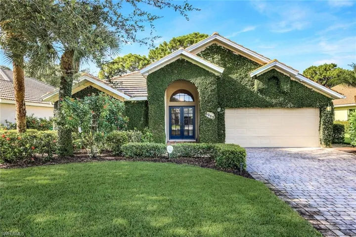 View of front facade with a garage and a front lawn
