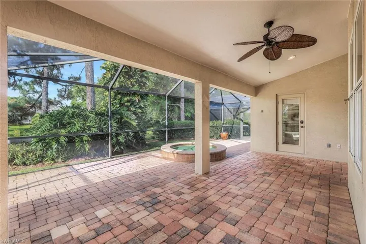 Unfurnished sunroom featuring ceiling fan