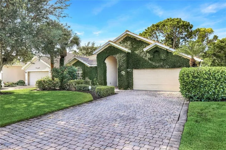View of front of home featuring a garage and a front lawn
