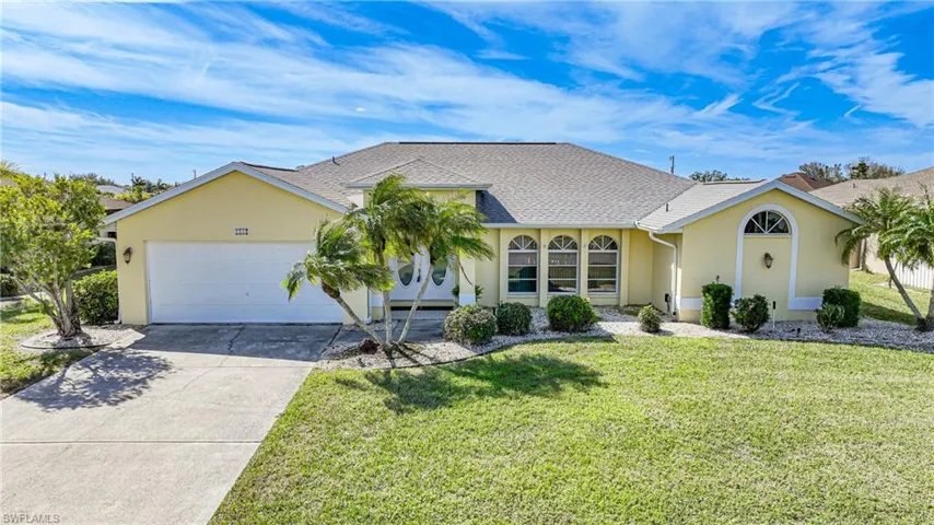 Ranch-style home featuring a garage and a front yard