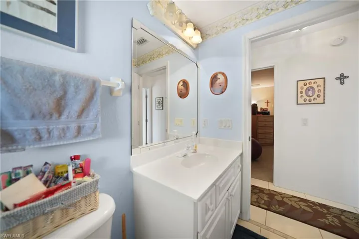 Bathroom featuring tile patterned flooring, vanity, and toilet