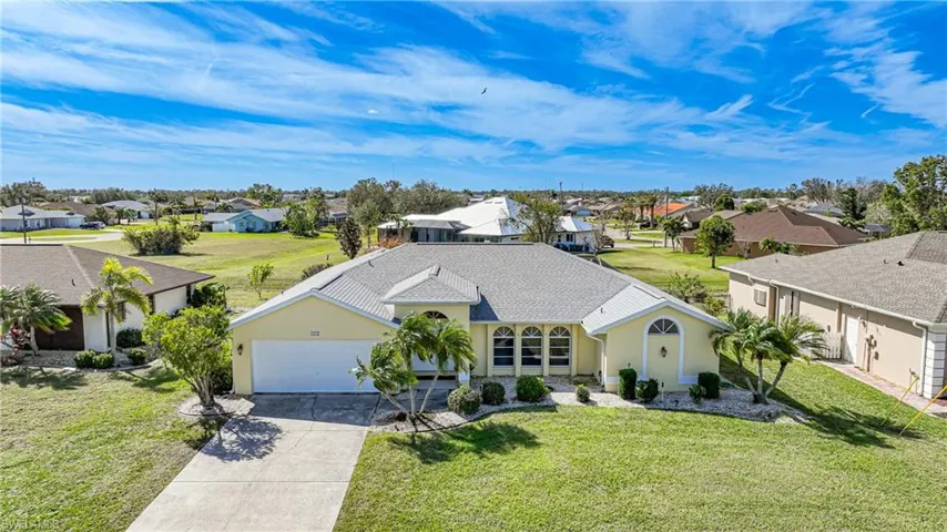 View of front of house featuring a garage and a front yard