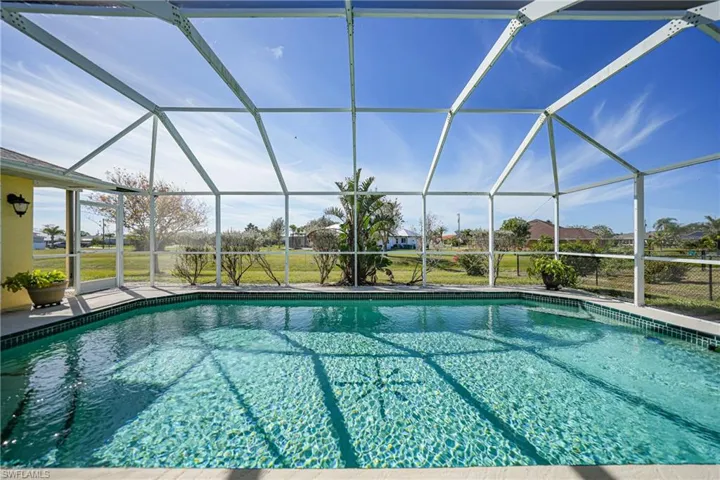 View of swimming pool with glass enclosure