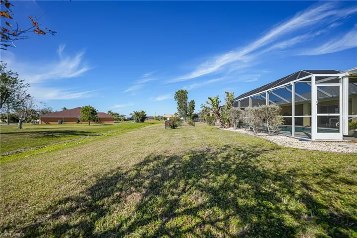 View of yard featuring glass enclosure