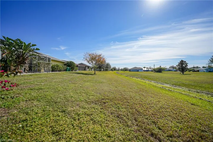 View of yard featuring glass enclosure