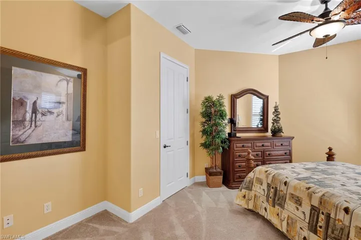 Bedroom featuring light colored carpet and a ceiling fan