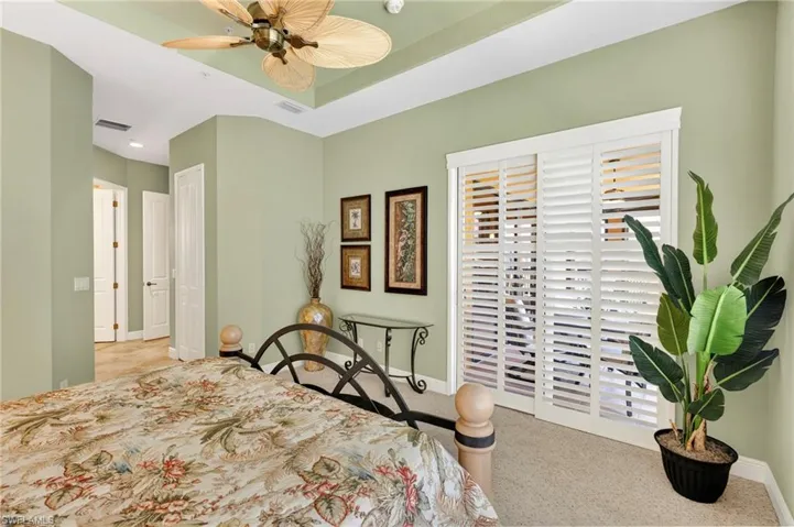 Bedroom featuring ceiling fan and light colored carpet
