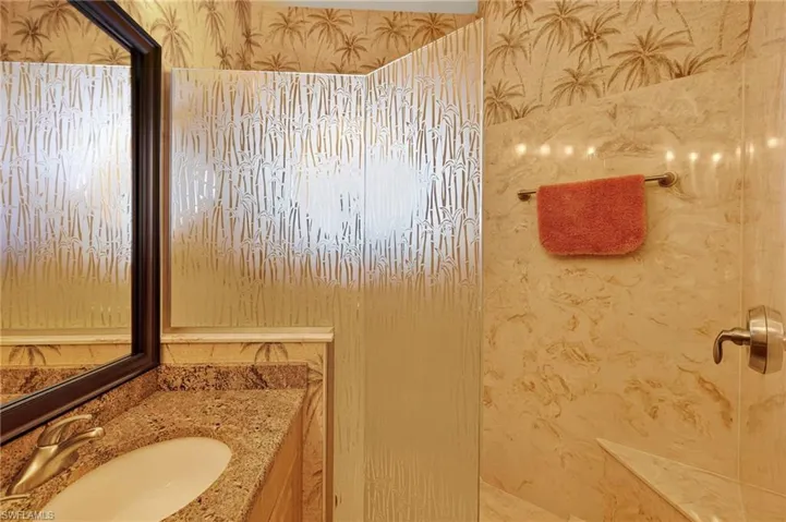Bathroom featuring vanity and wallpapered walls