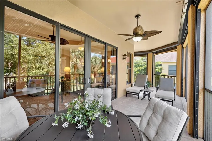 Sunroom / solarium with ceiling fan and outdoor dining area