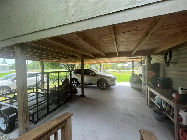 View of parking with a carport