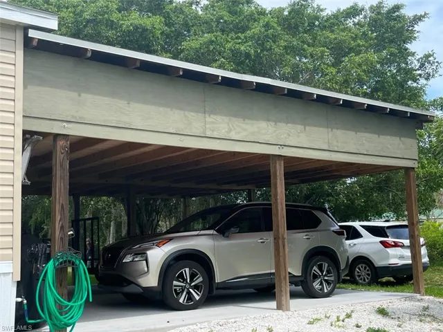 View of vehicle parking featuring a carport