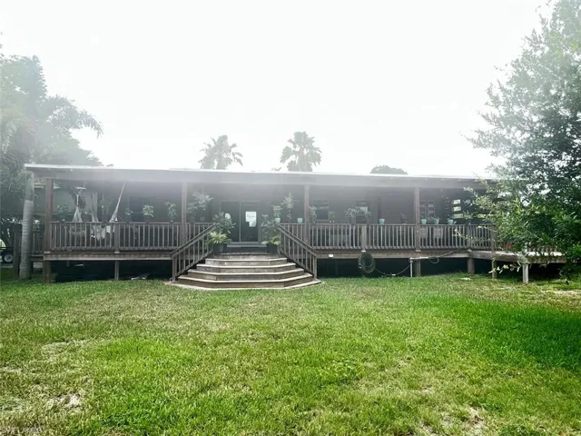 Rear view of house with a yard