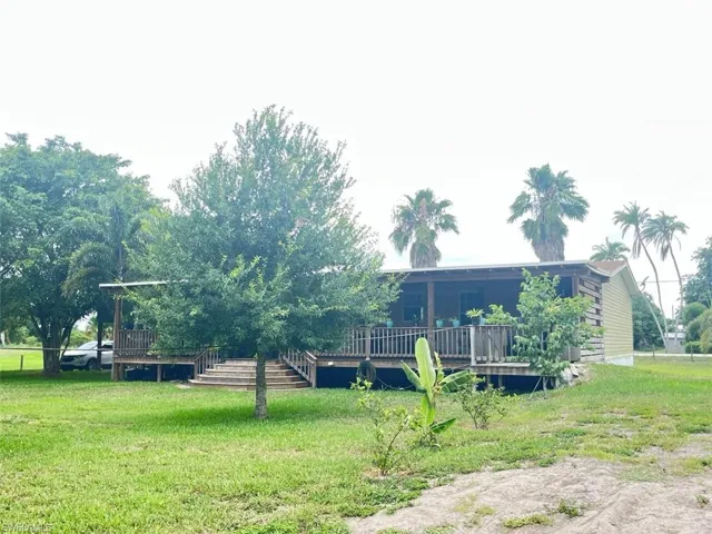 View of yard with a wooden deck