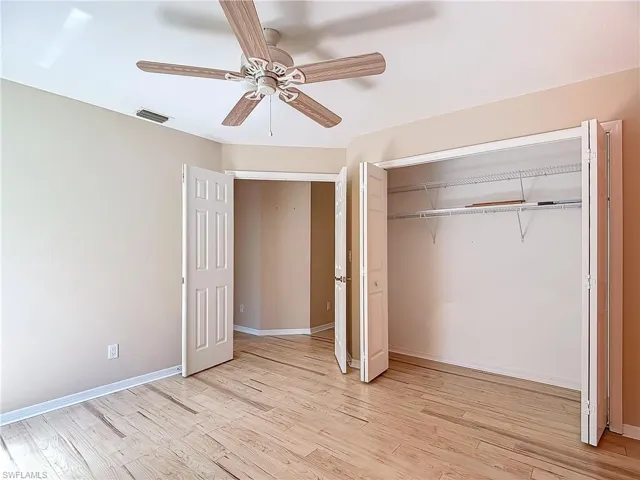 Unfurnished bedroom with ceiling fan, a closet, and light hardwood / wood-style floors