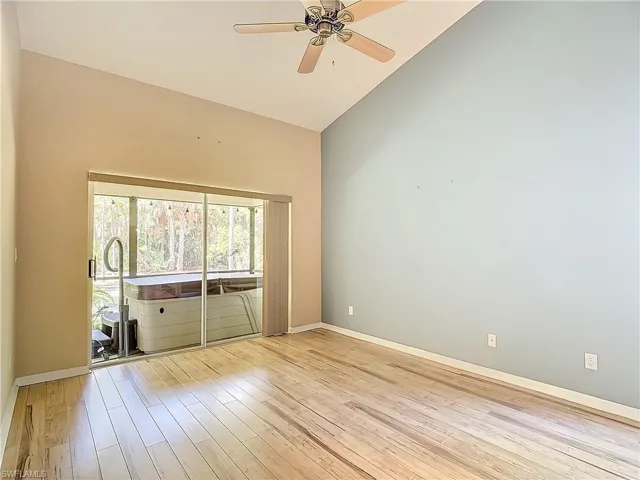 Unfurnished room featuring high vaulted ceiling, ceiling fan, and light wood-type flooring