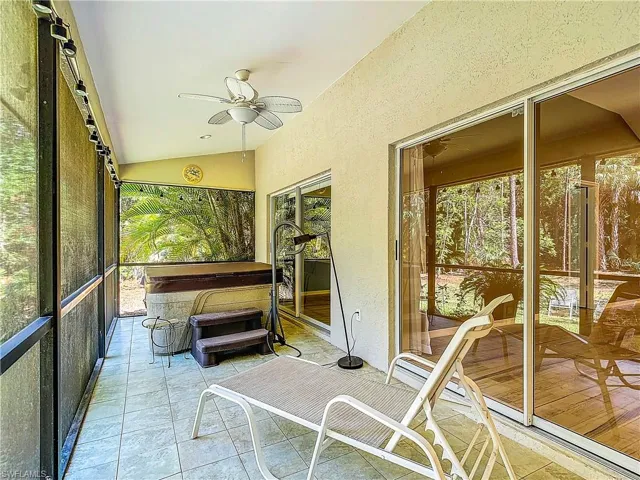 Unfurnished sunroom featuring ceiling fan