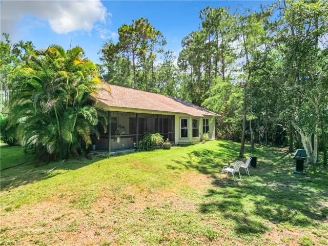 View of yard with a sunroom