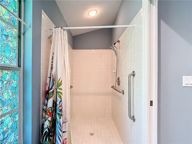 Bathroom featuring a shower with curtain