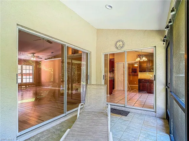 Unfurnished sunroom featuring ceiling fan
