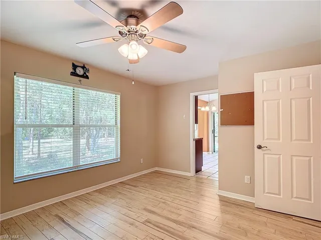 Spare room with ceiling fan and light wood-type flooring