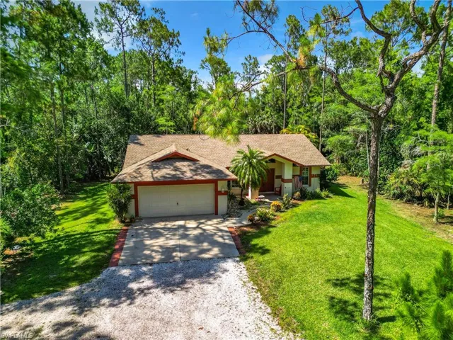 View of front of house featuring a front yard and a garage