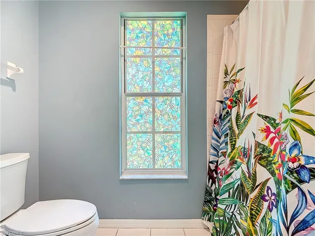 Bathroom with toilet and tile floors