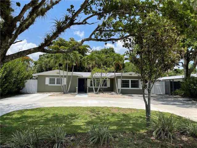 Ranch-style home featuring a garage and a front yard