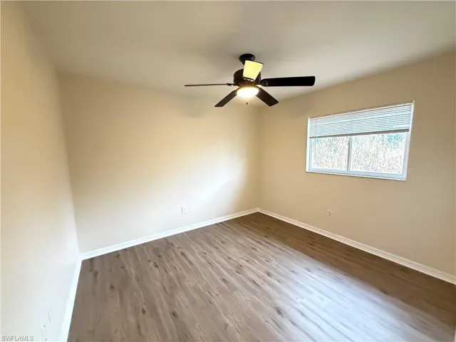 Unfurnished room with light wood finished floors and ceiling fan