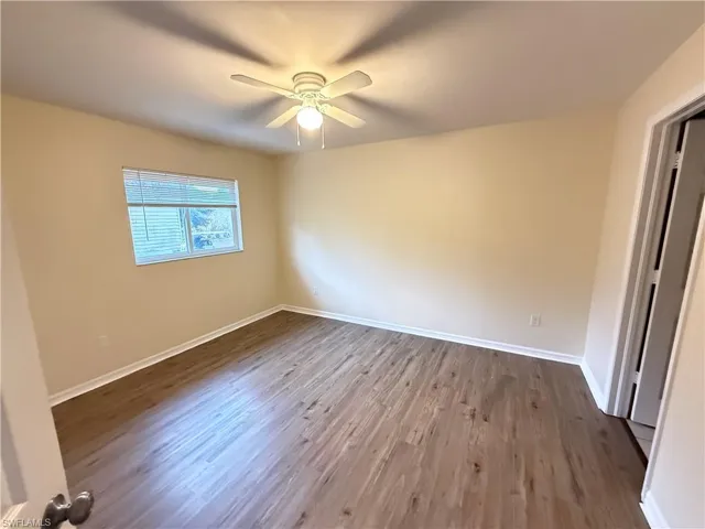 Empty room featuring light wood-style flooring and ceiling fan