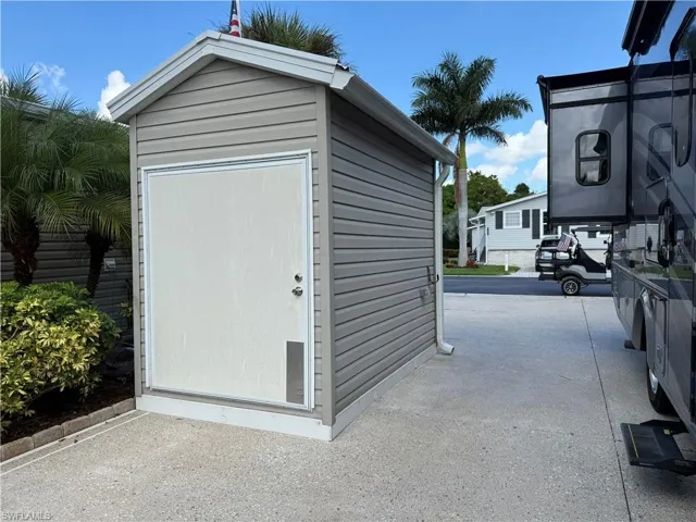 Detached storage shed with horizontal siding and a gabled roofline