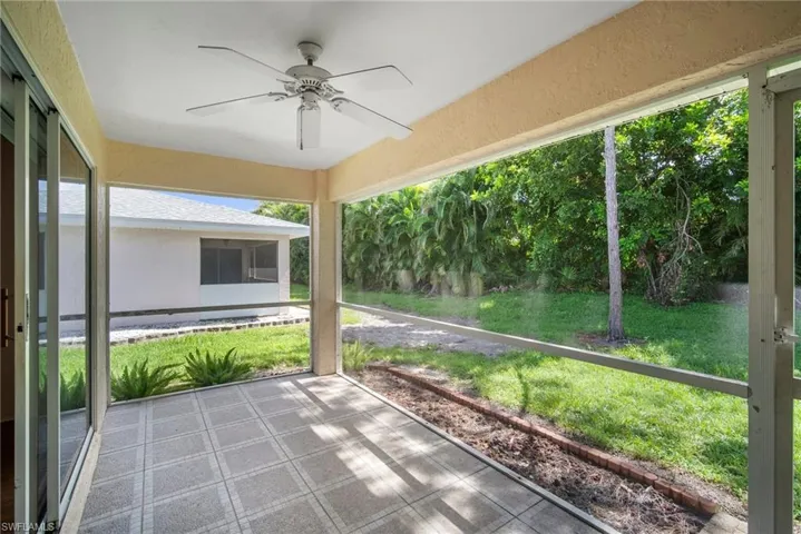 Unfurnished sunroom with ceiling fan