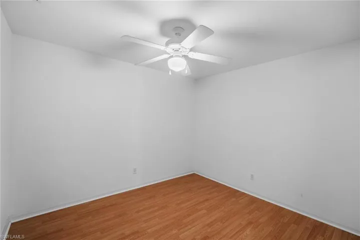 Spare room featuring ceiling fan and hardwood / wood-style floors