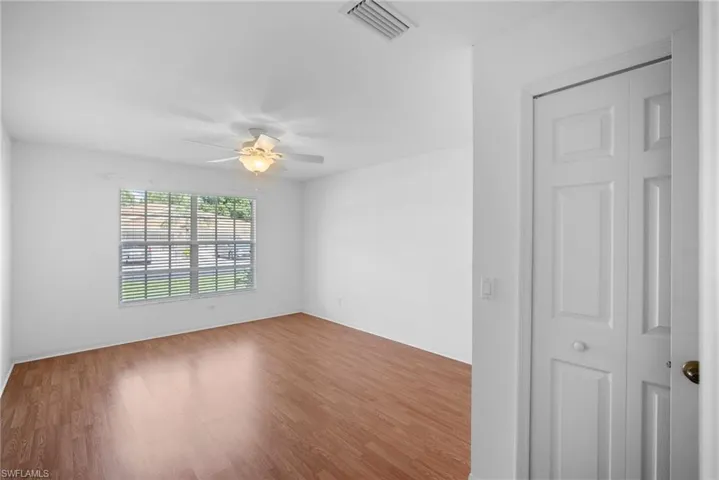Spare room featuring hardwood / wood-style flooring and ceiling fan