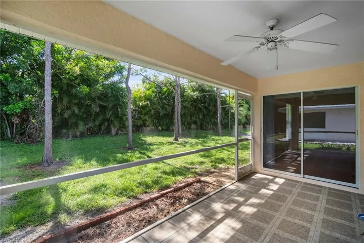 Unfurnished sunroom featuring ceiling fan