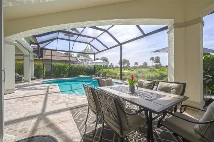 View of swimming pool featuring a patio and a lanai