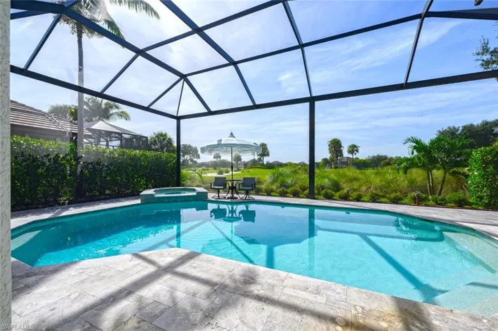 View of pool with a patio area and a lanai