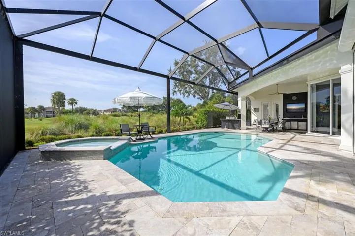 View of pool with a patio, an in ground hot tub, and a lanai