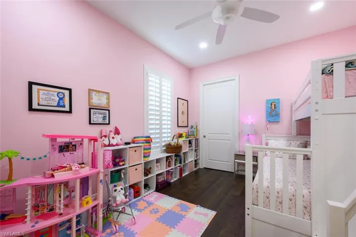 Bedroom featuring ceiling fan and dark wood-type flooring