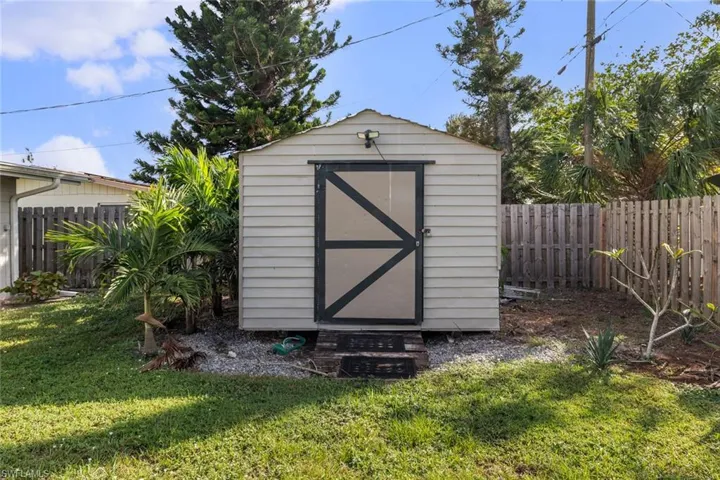 View of outdoor structure with a lawn